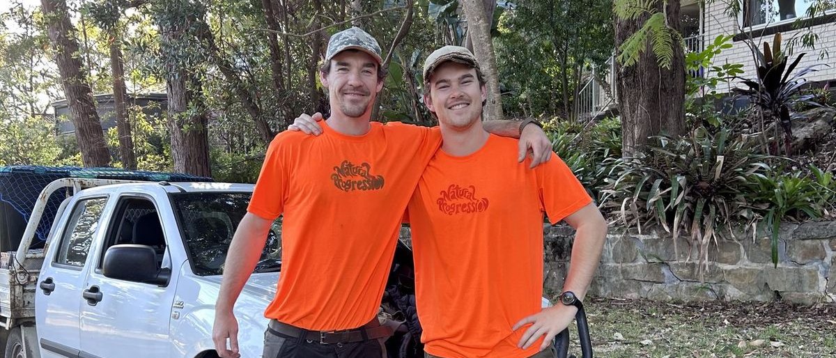 Finley and George standing together by the ute.